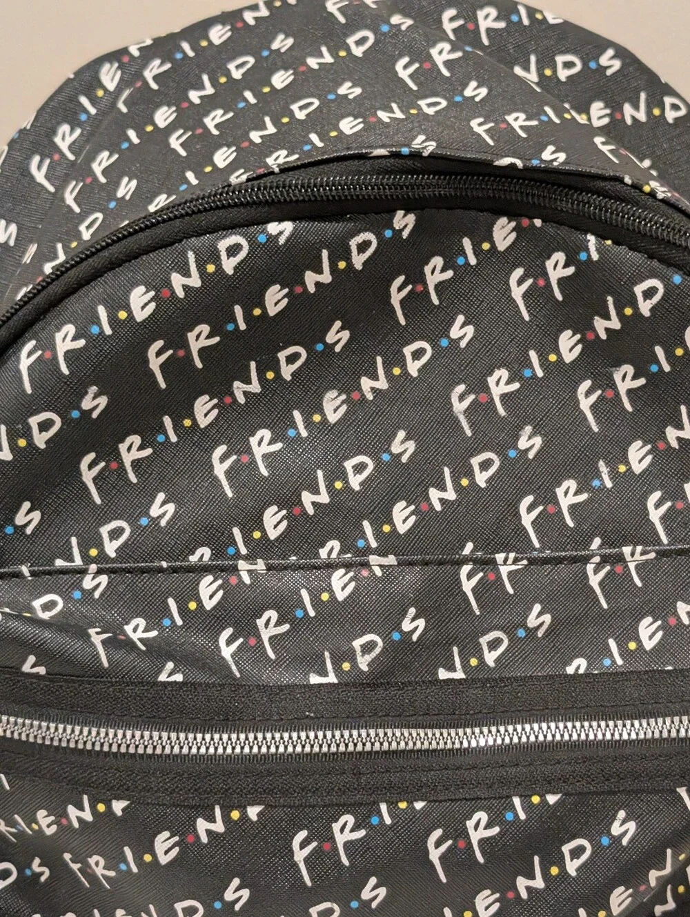 Friends Backpack all over print. need small repair see zoomed in photo
